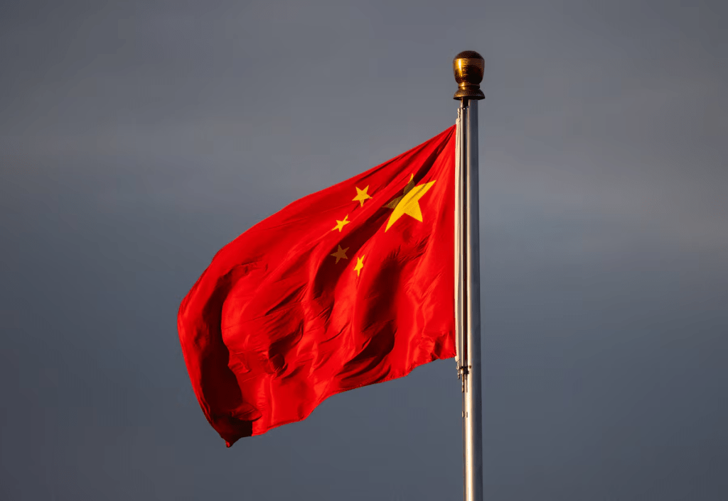 China’s national flag flutters in the wind lit by sunrise in Beijing, China, November 20, 2025. REUTERS/Maxim Shemetov 