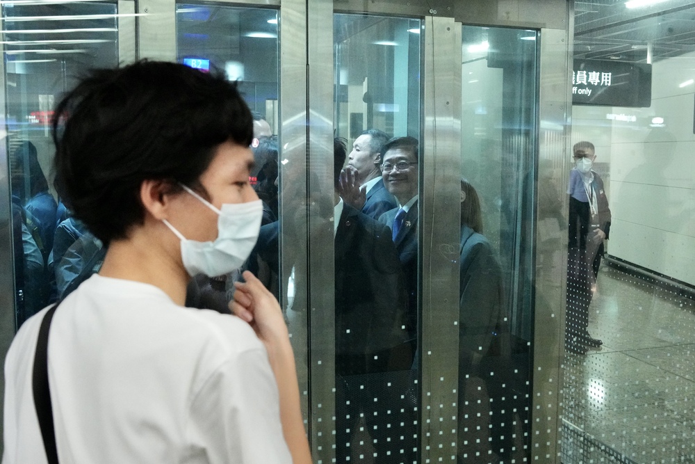 John Lee waves from a lift after arriving in Hong Kong. SING TAO John Lee waves from a lift after arriving in Hong Kong. SING TAO