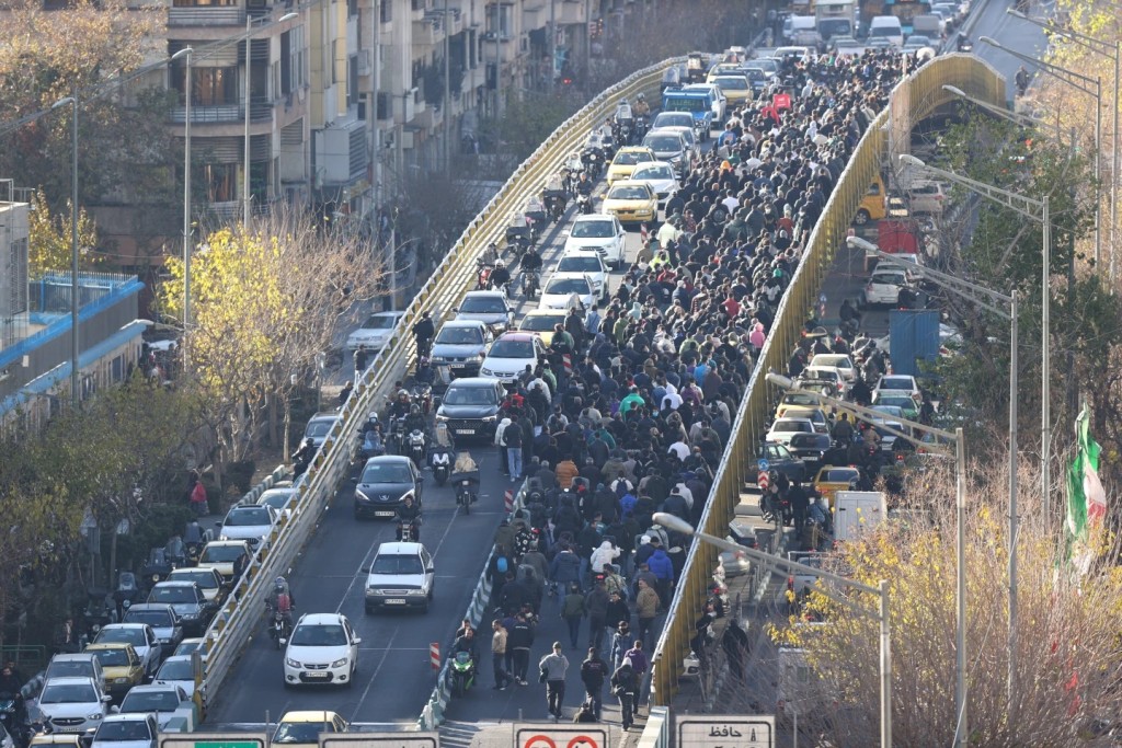 Protesters march on a bridge in Tehran, Iran, on Dec. 29, 2025. (Fars News Agency via AP, File)