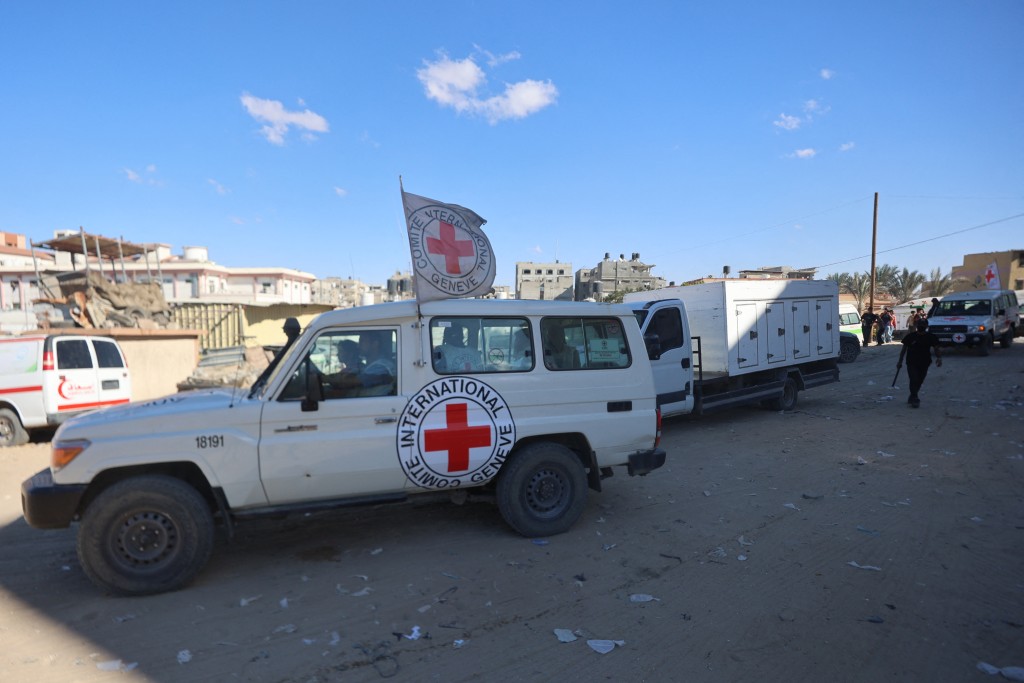 Red Crescent vehicles and refrigerated trucks, transporting the bodies of 45 Palestinians that had been in Israeli custody, arrive at the Nasser hospital in Khan Yunis in the southern Gaza Strip on October 14, 2025. Under a ceasefire deal brokered by US President Donald Trump, Israel was to turn over the bodies of 15 Palestinians for every deceased Israeli returned.   Photo by OMAR AL-QATTAA / AFP