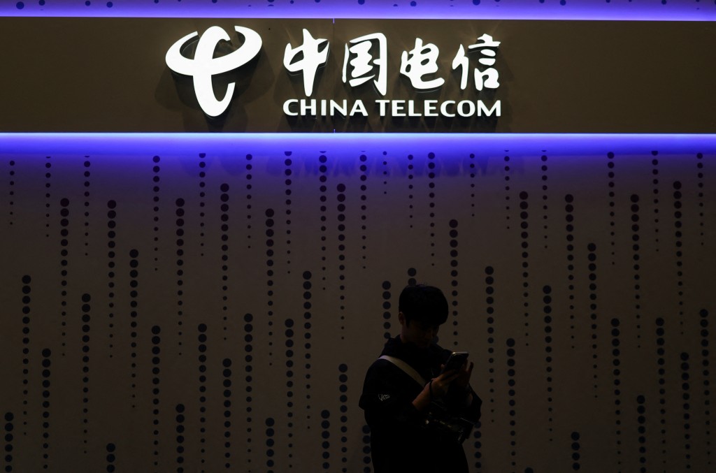 A visitor looks at his mobile at the China Telecom stand in the Mobile World Congress (MWC) in Barcelona, Spain March 3, 2026. REUTERS/Nacho Doce