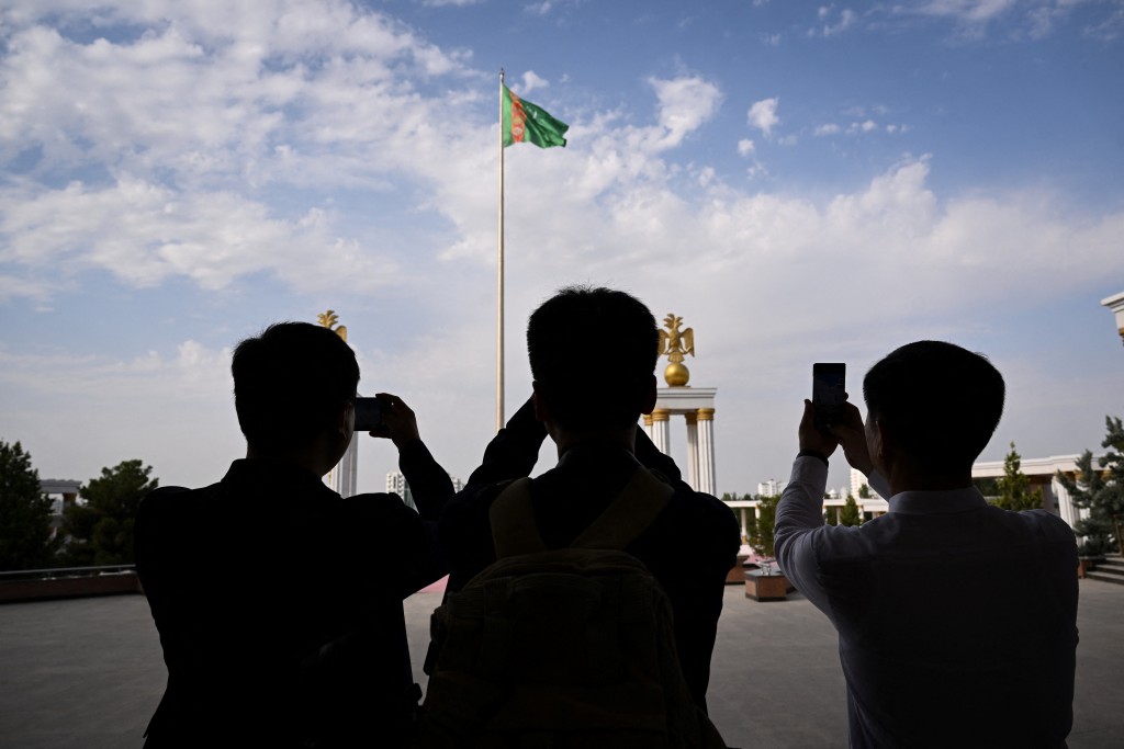 (FILES) The main flag of Turkmenistan sits in front of the State museum of the State cultural centre of Turkmenistan in the capital of Ashgabat on June 28, 2023. (Photo by Natalia KOLESNIKOVA / AFP)