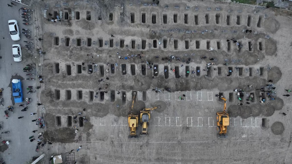 Graves are being prepared for the victims following a reported strike on a school in Minab, Iran, March 2, 2026. Iranian Foreign Media Department/WANA (West Asia News Agency)/Handout via REUTERS