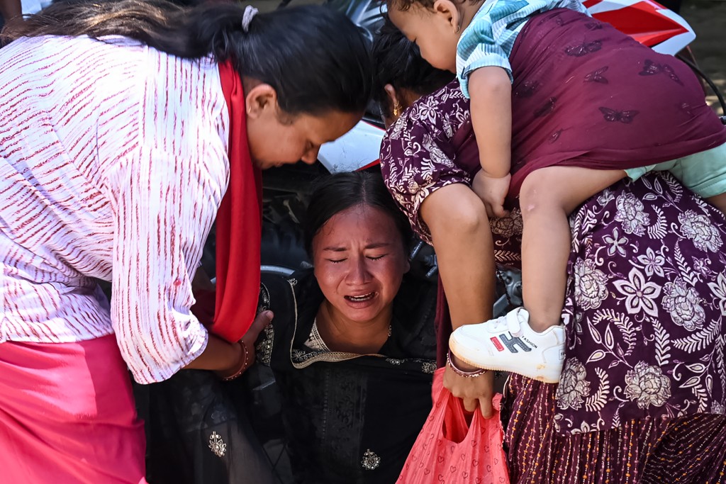 A woman breaks down as she waits for relatives to arrive at an army camp after being rescued from flash flood-affected areas, in Battar Bazar town in Nepal's Nuwakot district on August 27, 2026. A woman breaks down as she waits for relatives to arrive at an army camp after being rescued from flash flood-affected areas, in Battar Bazar town in Nepal's Nuwakot district on August 27, 2026.