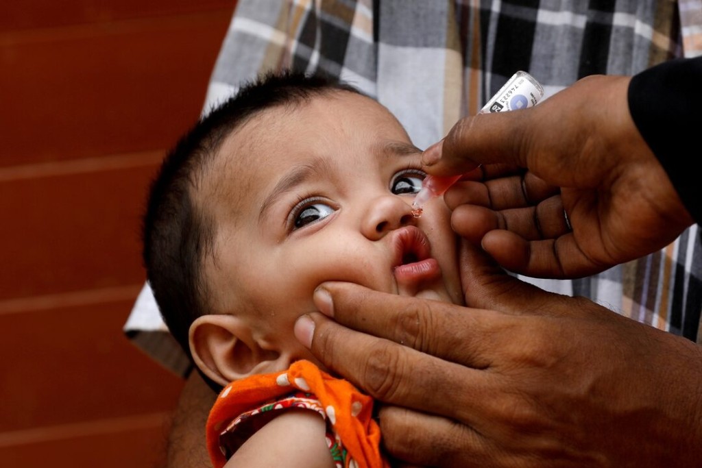 A girl receives polio vaccine drops, during an anti-polio campaign, in a low-income neighborhood as the spread of the coronavirus disease (COVID-19) continues, in Karachi, Pakistan July 20, 2020. REUTERS/Akhtar Soomro