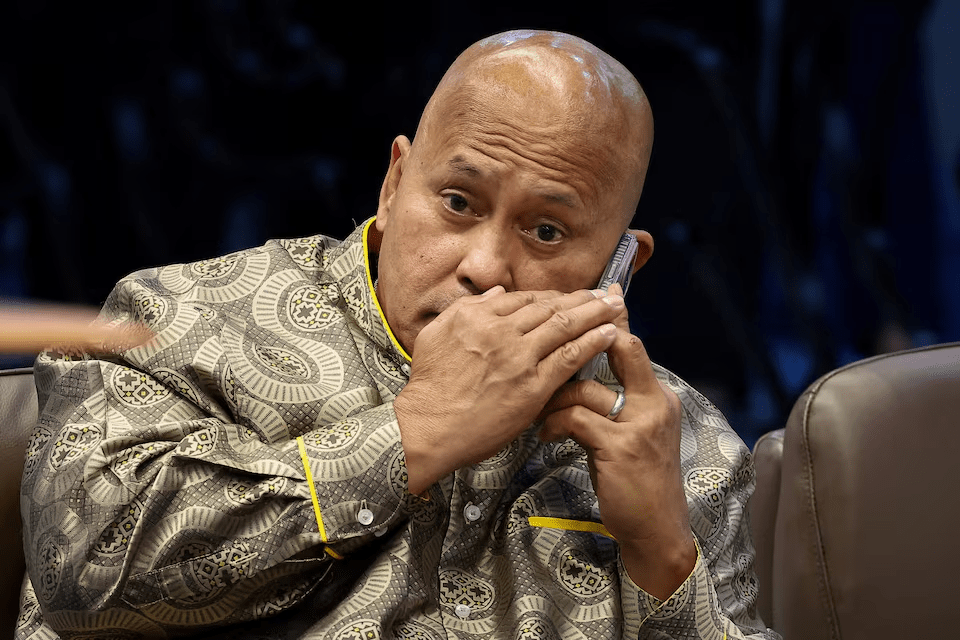 Philippine Senator Ronald "Bato" dela Rosa, the chief enforcer of former president Rodrigo Duterte's drug war, takes a phone call during a session at the Senate, which holds him under protective custody amid an International Criminal Court warrant, in Pasay City, Metro Manila, Philippines, May 13, 2026. REUTERS/Eloisa Lopez/File Photo