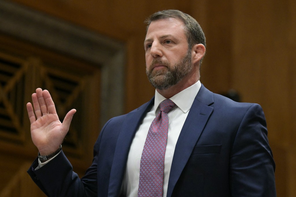 Photo by OLIVER CONTRERAS / AFP  US Senator Markwayne Mullin (R-OK), nominee to be Secretary of Homeland Security, is sworn in during a Senate Committee on Homeland Security and Governmental Affairs confirmation hearing on Capitol Hill in Washington, DC, on March 18, 2026.