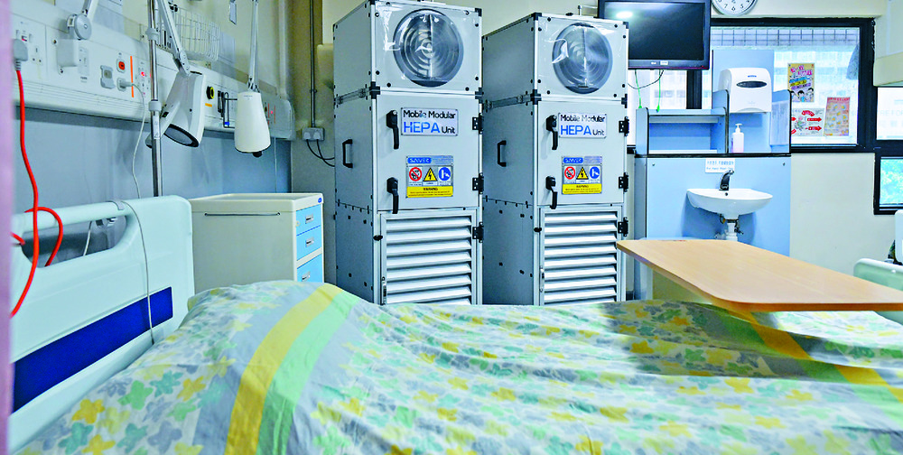 Rare is this empty bed in an isolation ward, with William Tang, right, among those awaiting hospitalization. Rare is this empty bed in an isolation ward, with William Tang, right, among those awaiting hospitalization.