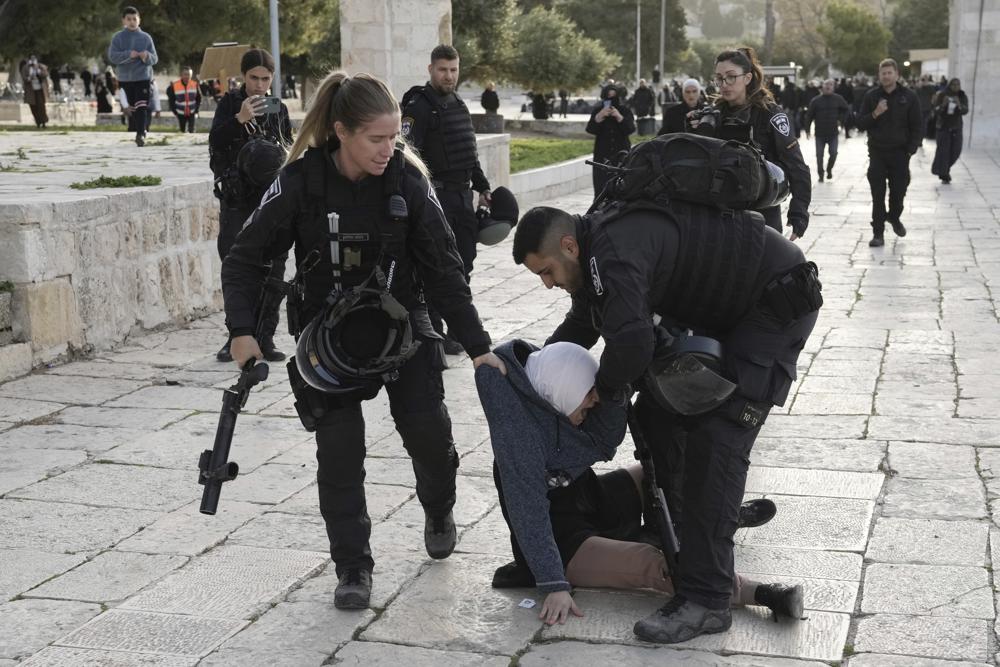 Israeli police arrest a Palestinian woman at the Al-Aqsa Mosque compound following a raid at the site in the Old City of Jerusalem during the Muslim holy month of Ramadan, Wednesday, April 5, 2023. (AP) Israeli police arrest a Palestinian woman at the Al-Aqsa Mosque compound following a raid at the site in the Old City of Jerusalem during the Muslim holy month of Ramadan, Wednesday, April 5, 2023. (AP)