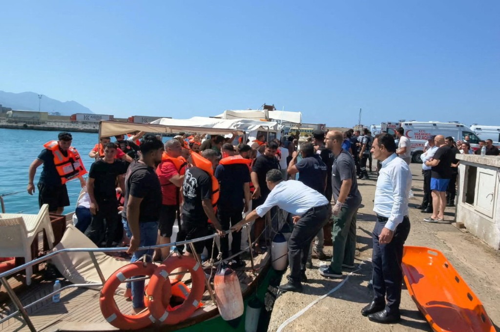 Survivors arrive on shore after being rescued from the sea following a boat capsize off Kyrenia, northern Cyprus, August 30, 2026. (Reuters)