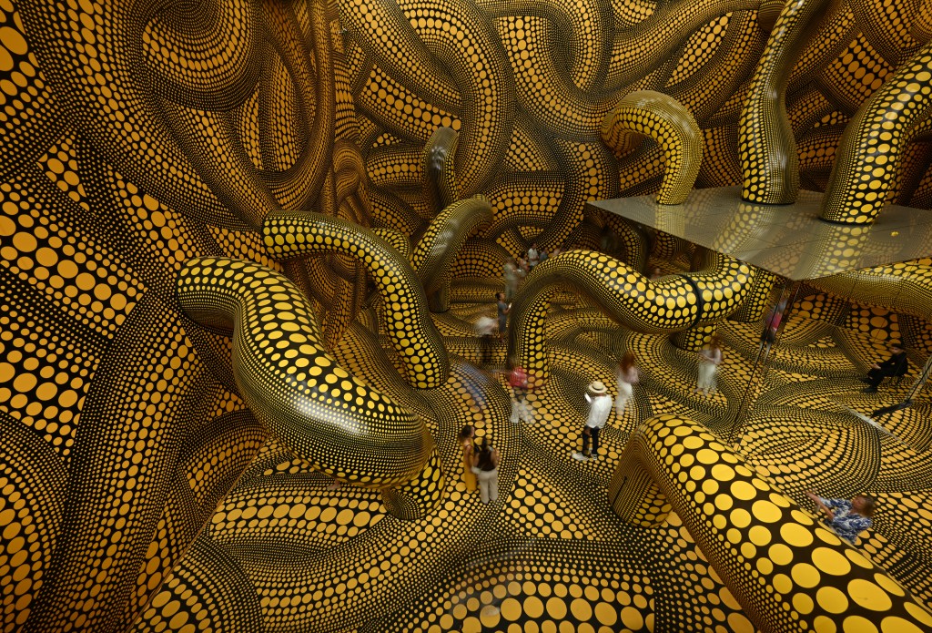 Visitors walk through the installation 'Infinity Mirrored Room – The Hope of the Polka Dots Buried in Infinity Will Eternally Cover the Universe' during the last day of the exhibition 'Yayoi Kusama' by Japanese artist Yayoi Kusama at the Museum Ludwig in Cologne, western Germany (AFP) Visitors walk through the installation 'Infinity Mirrored Room – The Hope of the Polka Dots Buried in Infinity Will Eternally Cover the Universe' during the last day of the exhibition 'Yayoi Kusama' by Japanese artist Yayoi Kusama at the Museum Ludwig in Cologne, western Germany (AFP)