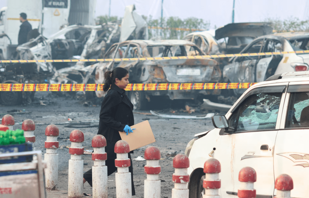 A member of the forensic team works at the site of an explosion near the historic Red Fort in the old quarters of Delhi, India, November 11, 2025. REUTERS/Adnan Abidi
