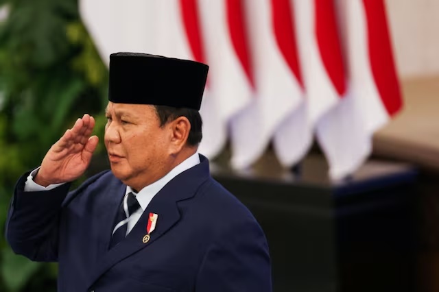 Indonesian President Prabowo Subianto salutes for the National anthem during reshuffle cabinet ceremony at a Presidential Palace in Jakarta, Indonesia, April 27, 2026. REUTERS/Ajeng Dinar Ulfiana