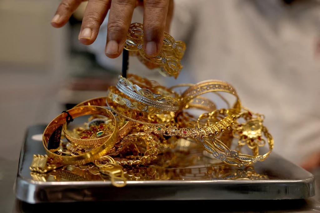 A goldsmith weighs gold jewellery inside a showroom in Ahmedabad, India, July 31, 2025. REUTER