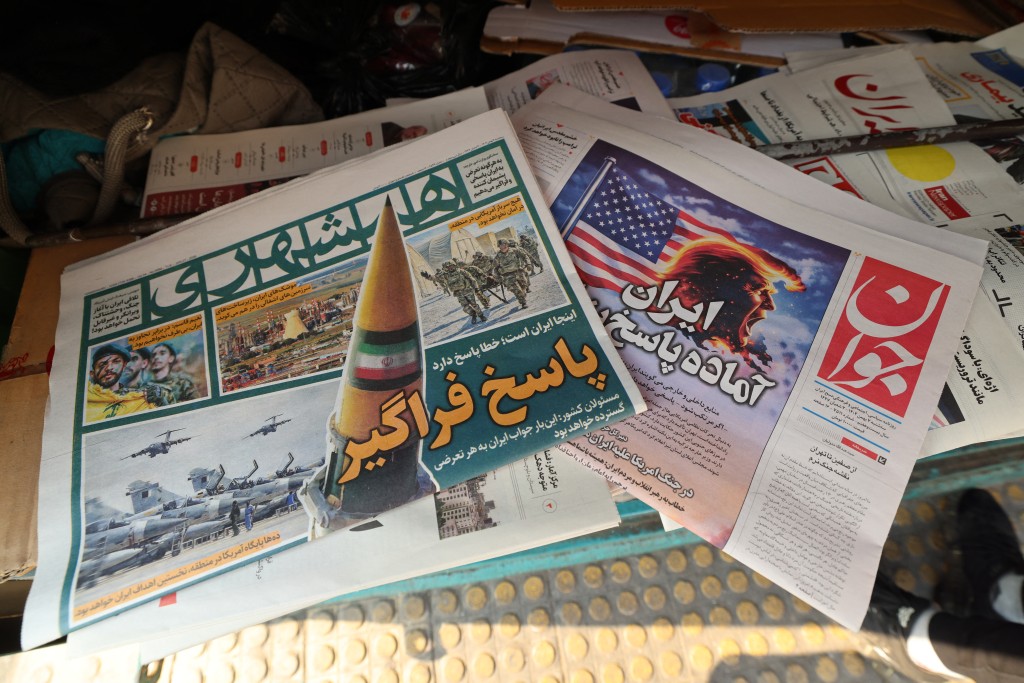 A photograph shows newspapers, one of them (R) with a headline in Persian reading “Iran is ready for a big response”, at a kiosk in Tehran on January 27, 2026. (AFP)