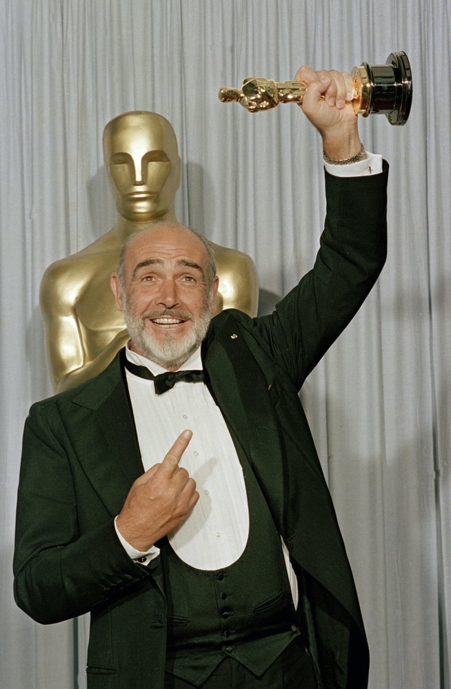 In this file photo dated April 11, 1988, Sean Connery holds up his best supporting actor Oscar for The Untouchables at the 60th annual Academy Awards in Los Angeles, California.