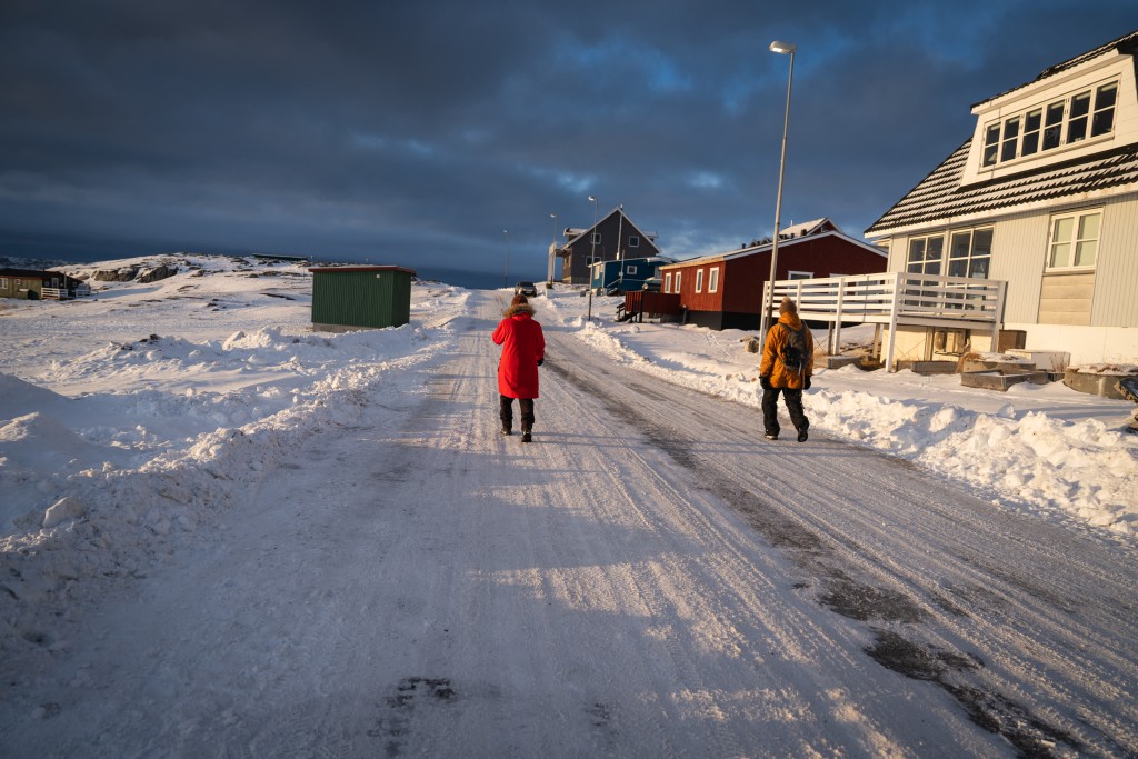 People enjoy an afternoon walk on January 15, 2026 in Nuuk, Greenland. (Photo by Alessandro RAMPAZZO / AFP)