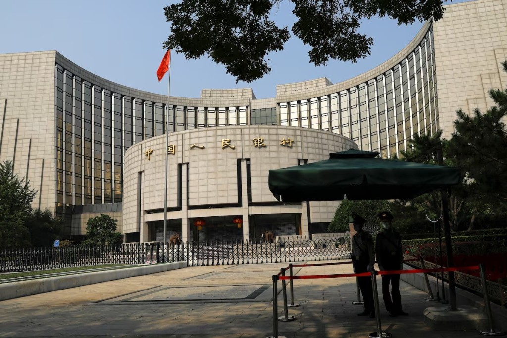 Paramilitary police officers stand guard in front of the headquarters of the People's Bank of China, the central bank (PBOC), in Beijing, China September 30, 2022. REUTERS