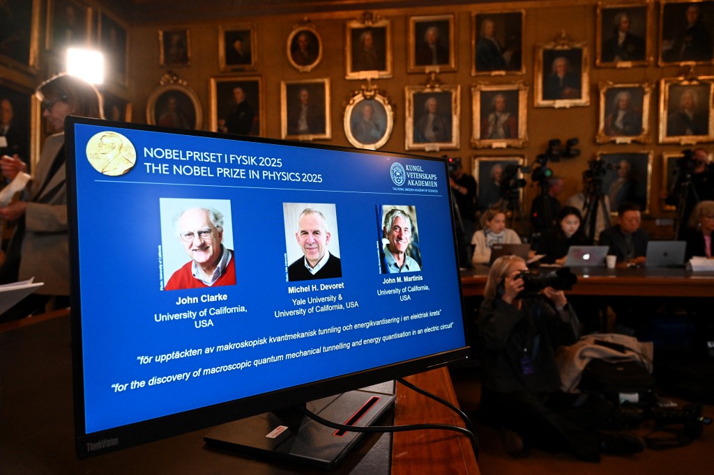 Photos of (LtoR) British physicist John Clarke at the University of California, USA, French physicist Michel H Devoret (University of California and Yale) and US physicist John M Martinis (University of California) are seen on a screen during a press conference on the awarding of the 2025 Nobel Prize in Physics at the Royal Swedish Academy of Sciences in Stockholm, Sweden. (AFP)