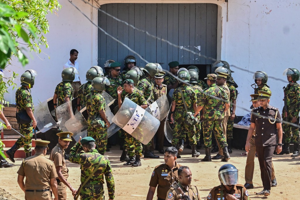 Sri Lanka's Special Task Force (STF) personnel stand guard outside the Negombo prison near Colombo on July 6, 2026 following overnight clashes between inmates and guards. (AFP)