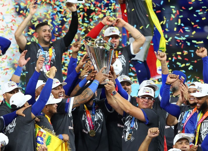 Catcher Salvador Perez, left, lifts the trophy after Venezuela’s win over the US in the World Baseball Classic final. AFP