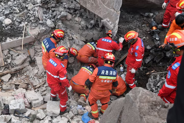 Rescue workers search for survivors in the debris after a landslide hit Zhenxiong County, in Zhaotong, Yunnan province, China January 22, 2024. China Daily via REUTERS 