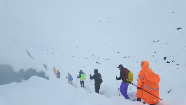A screen capture from video shows trekkers leaving their campsite, as unusually heavy snow and rainfall pummeled the Himalayas, in the Tibet Region, China, October 5, 2025. Geshuang Chen/Handout via REUTERS