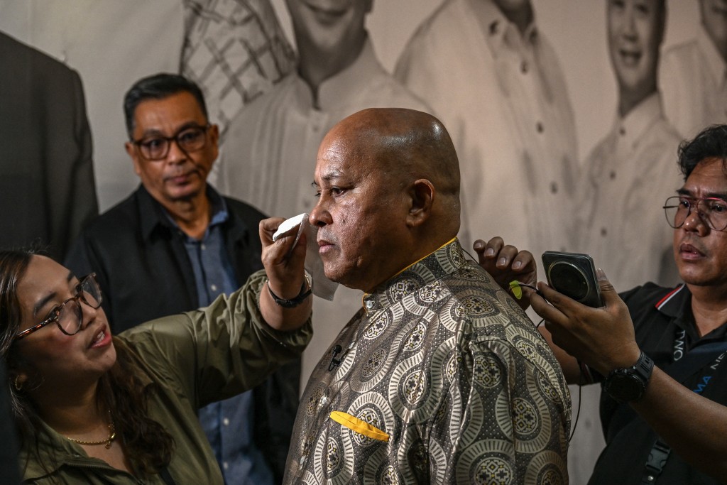 Photo by JAM STA ROSA / AFP Philippines' Senator Ronald Dela Rosa prepares for an interview at the Senate of the Philippines in Pasay, Metro Manila on May 13, 2026.