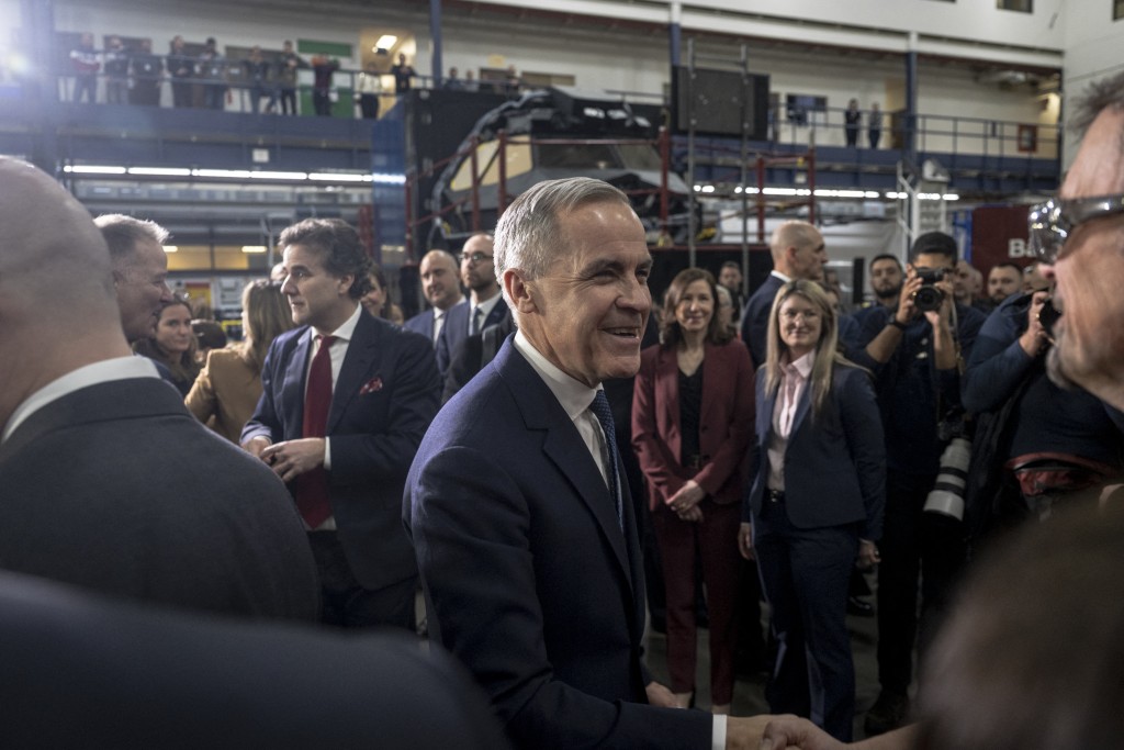 Canadian Prime Minister Mark Carney greets people after making an announcement on new measures to strengthen security, create prosperity, and reinforce strategic autonomy at Canadian Aviation Electronics (CAE), a flight simulation company, in Montreal, Quebec, Canada, on February 17, 2026. (Photo by ANDREJ IVANOV / AFP)
