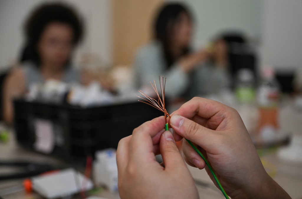 Photo by PEDRO PARDO / AFP  This picture taken on June 28, 2026 shows women attending an electricity course at the Mulan Build workshop in Hangzhou, in eastern China's Zhejiang province.
