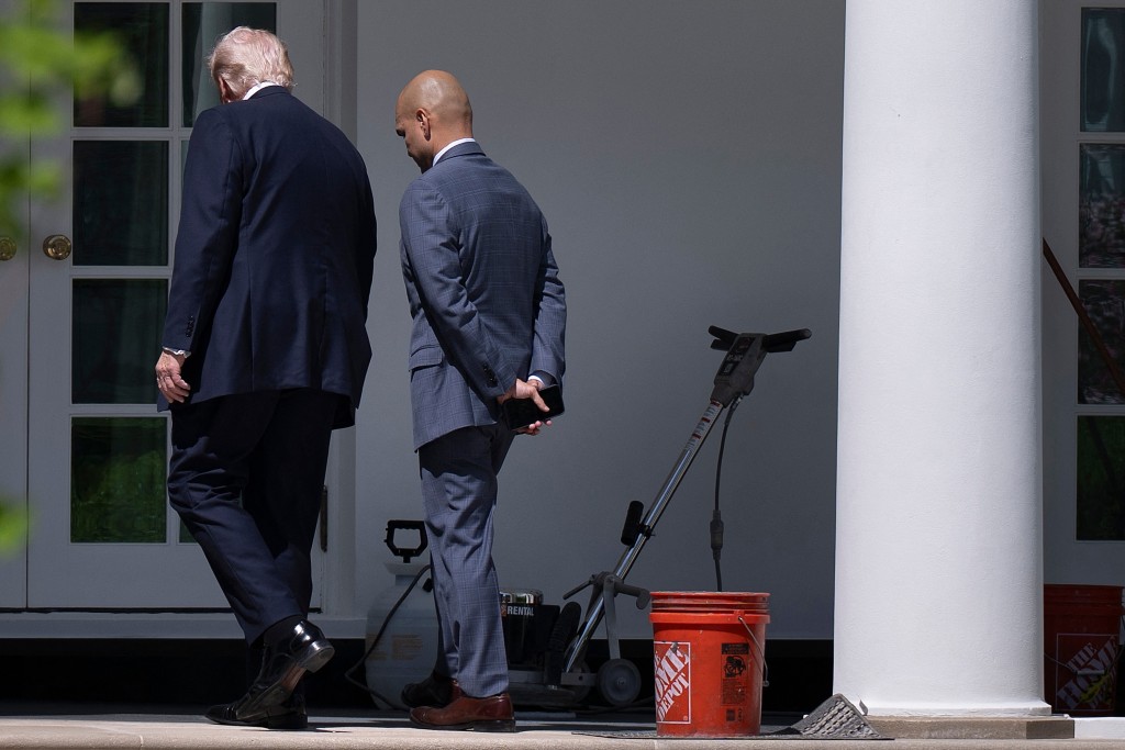 US President Donald Trump looks at granite in the colonnade with White House Director of Oval Office Operations Walt Nauta while it is installed along the West Wing of the White House April 30, 2026, in Washington, DC. (Photo by Brendan Smialowski / AFP)