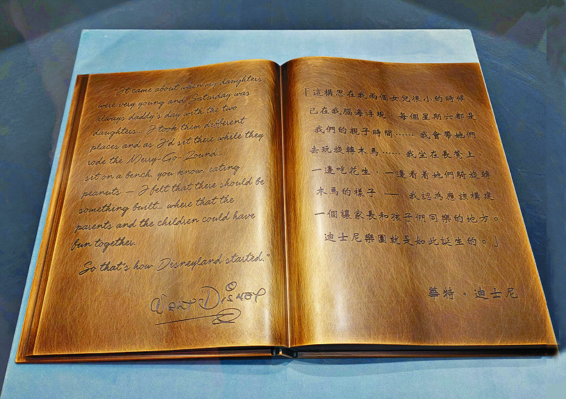 The book-shaped plaque, which features Walt Disney's signature style, and a Smoke Tree Ranch logo on his tie. 
