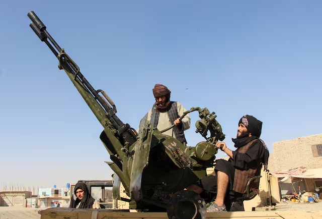 An Afghan Taliban fighter sit next to an anti-aircraft gun near the Afghanistan-Pakistan border in Spin Boldak, Kandahar Province, following exchanges of fire between Pakistani and Afghan forces in Afghanistan, October 15, 2025. REUTERS/Stringer