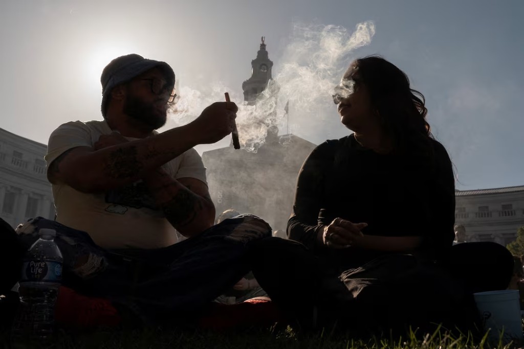 Revellers smoke cannabis at the Mile High 420 Festival in Denver, Colorado, U.S., April 20, 2026. REUTERS/Cheney Orr