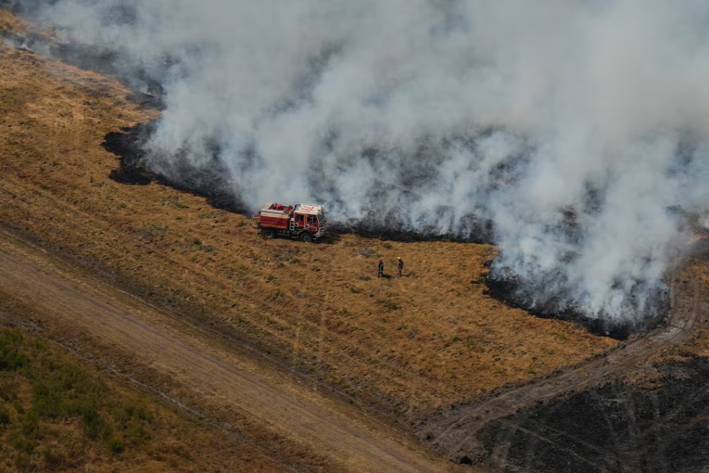  Firefighters work to suppress a fire near Ares, during wildfires in the area of southwestern France, Tuesday, July 28, 2026. Baz Ratner/Pool via REUTERS 