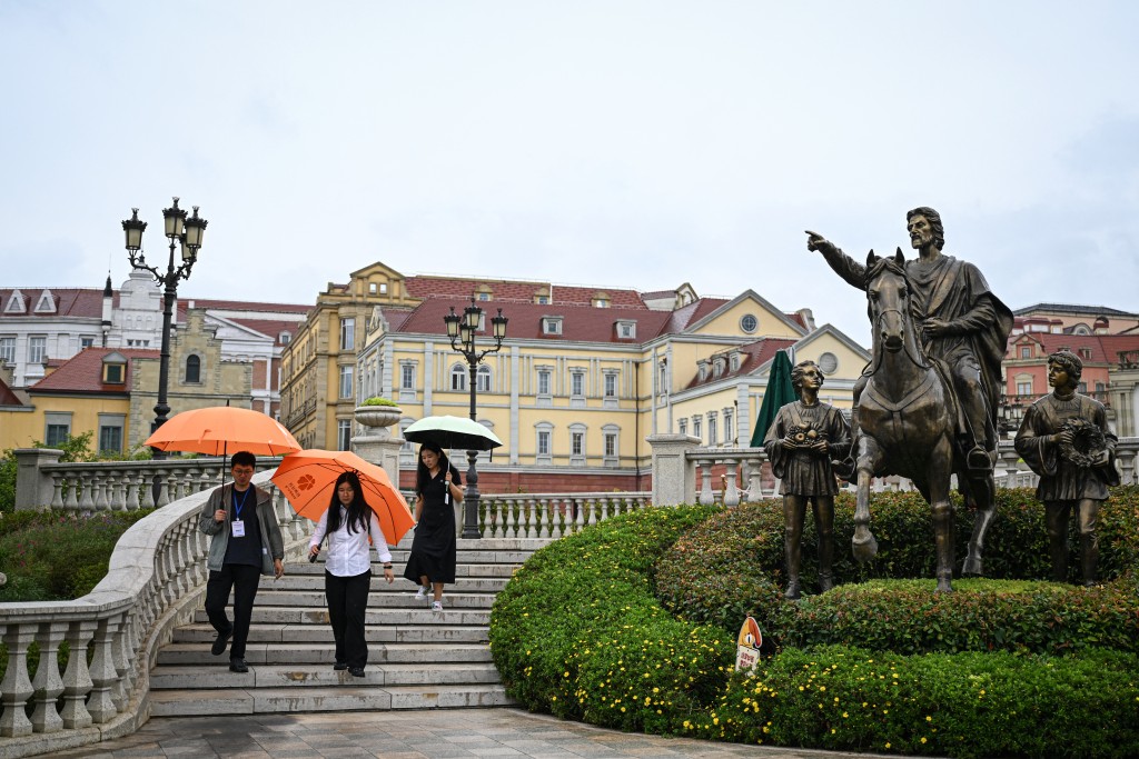 Photo by JADE GAO / AFP  The photo taken on July 24, 2026 shows employees walking out of Chinese technology company Huawei's European-themed data center in Guian New Area in Guiyang, in southwestern China's Guizhou Province.