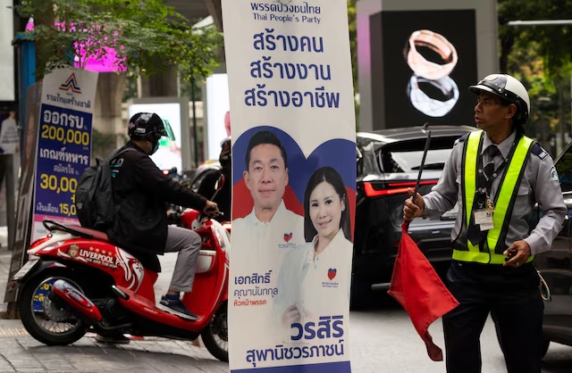 A security officer looks on next to the People's Party electoral campaign posters, before Thailand general elections on February 8, in Bangkok, Thailand, February 4, 2026. REUTERS/Maxim Shemetov