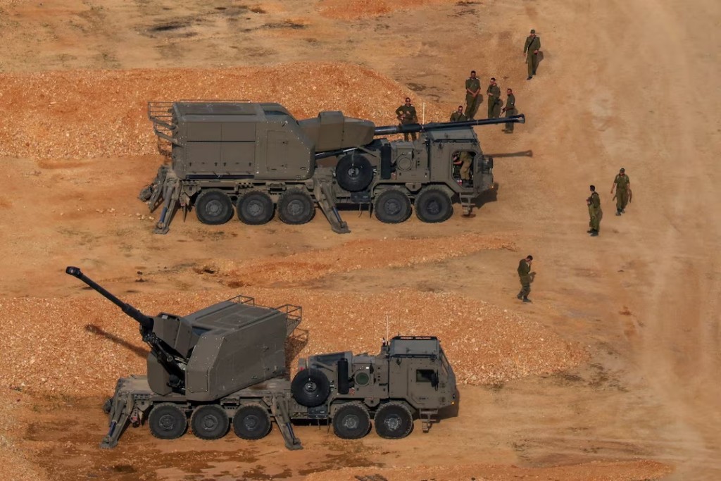 Israeli soldiers next to artillery vehicles near the Israel-Lebanon border, in northern Israel, April 15, 2026. REUTERS/Florion Goga