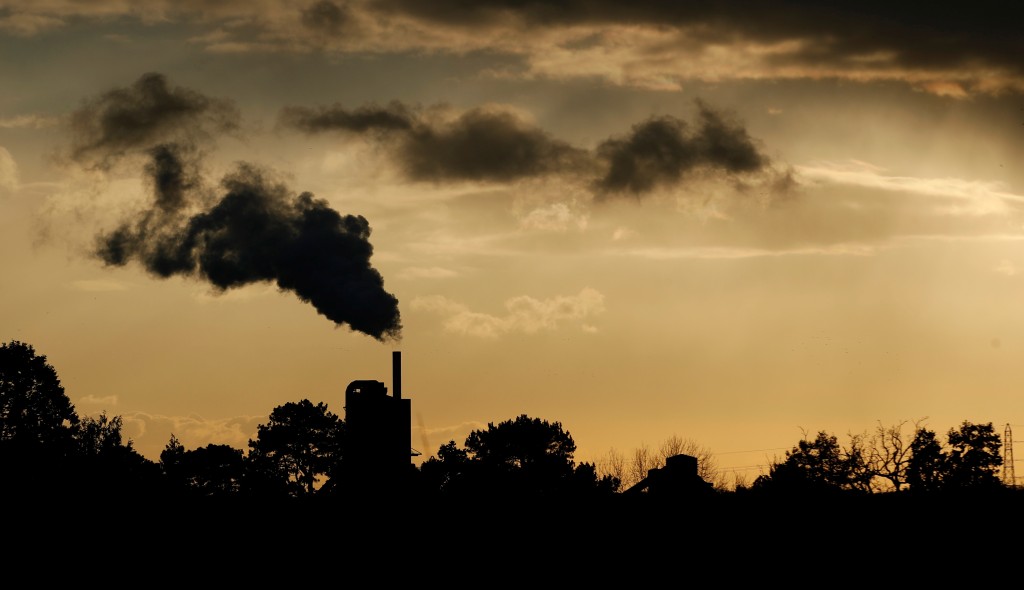 Smoke rises above a factory at sunset in Rugby, Britain February 10, 2021. REUTERS/Matthew Childs