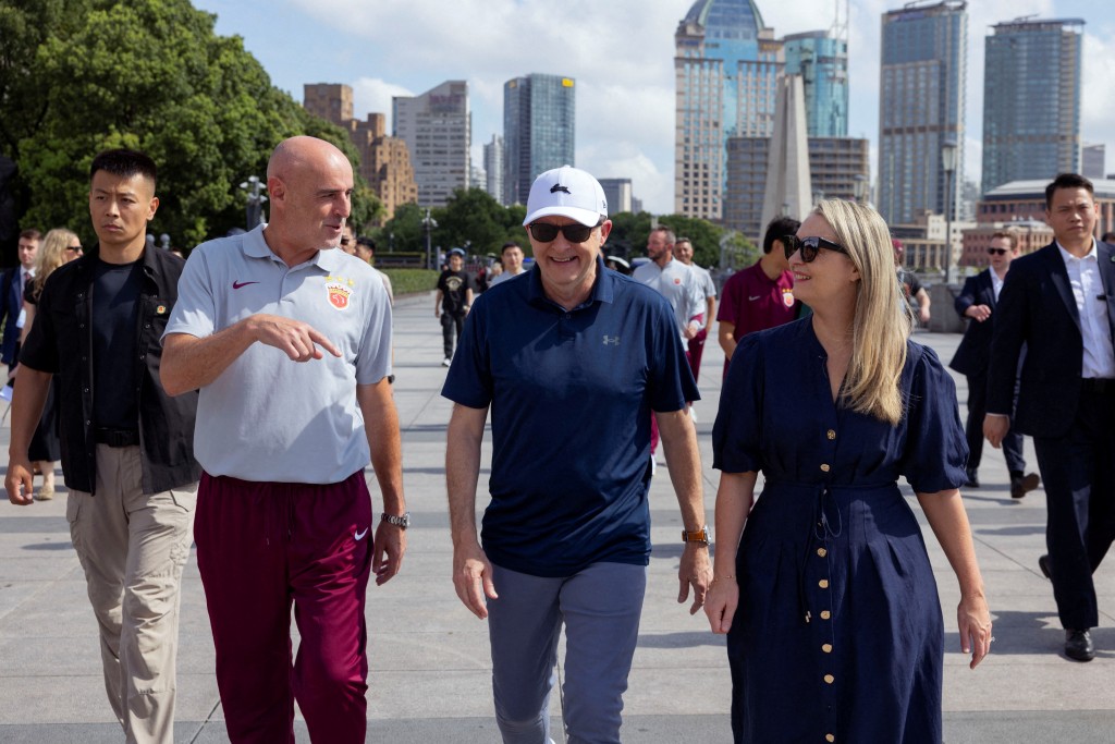 Australia's Prime Minister Anthony Albanese and his fiancee Jodie Haydon walk along the Bund with Shanghai Port FC Manager Kevin Muscat, in Shanghai, China July 13, 2025. (Reuters)