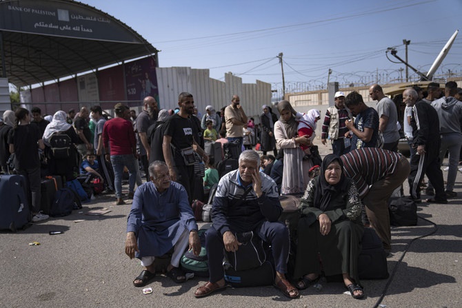 Palestinians wait to cross into Egypt at the Rafah border crossing in the Gaza Strip on Oct. 16, 2023. (AP) Palestinians wait to cross into Egypt at the Rafah border crossing in the Gaza Strip on Oct. 16, 2023. (AP)