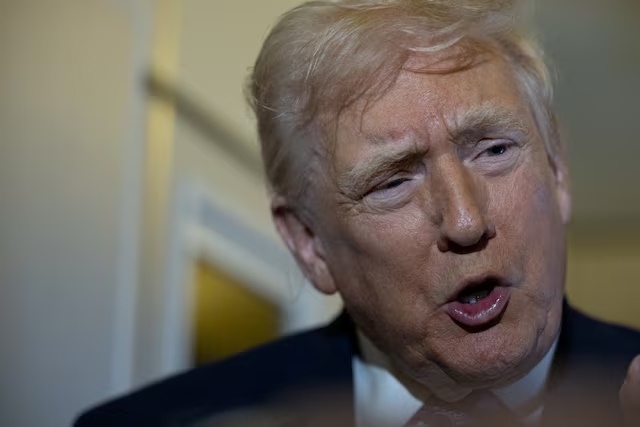 U.S. President Donald Trump speaks to reporters during travel to Washington, D.C., from Palm Beach International Airport, Florida, U.S., November 30, 2025. REUTERS/Anna Rose Layden/File Photo
