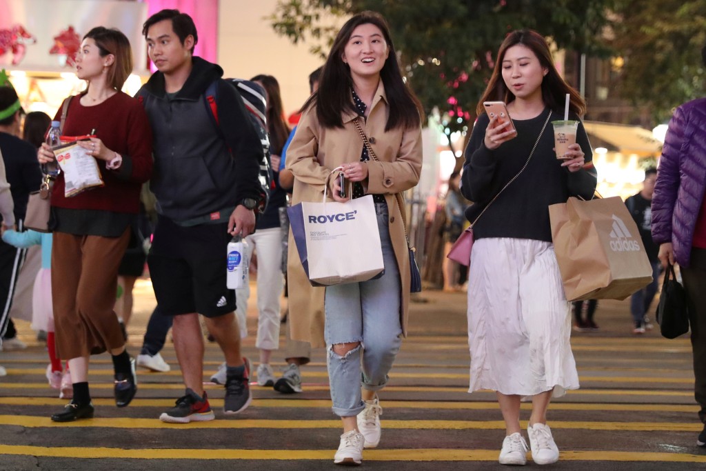 Shoppers cross the road outside Causeway Bay shopping mall in Hong Kong, China. REUTERS