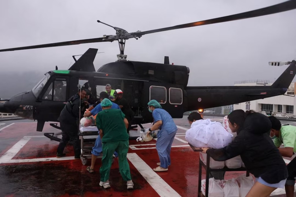 Medical crew carry a patient who is in critical condition, on a stretcher, as they transfer to a military helicopter from Hat Yai Hospital to Songklanagarind Hospital, amid heavy flooding in Hat Yai district, which was affected by heavy rainfall impacting several provinces in southern Thailand and killing several people, in Songkhla province, Thailand, November 26, 2025. Royal Thai Army/Handout via REUTERS