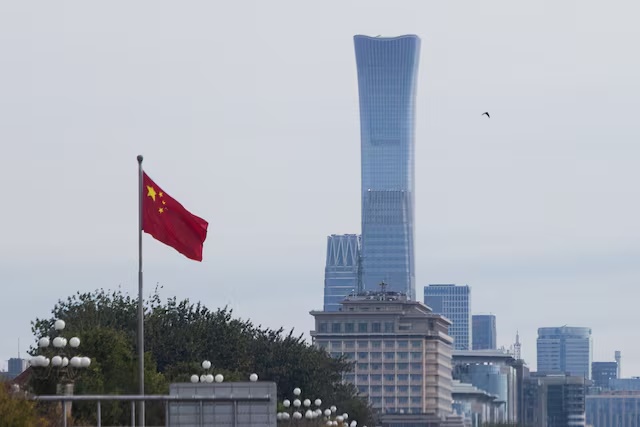 Chinese national flag flies in front of skyscrapers of the Central Business District (CBD) as China’s Communist Party leaders open the fifth plenary session of the 20th Central Committee behind closed doors, in Beijing, China, October 26, 2026. REUTERS/Maxim Shemetov