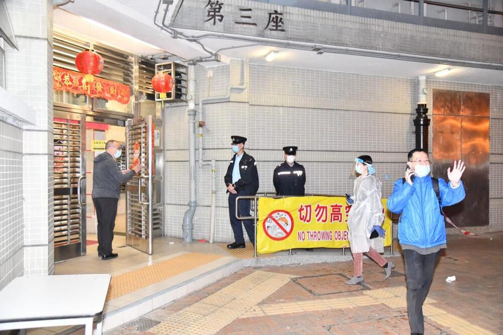 Residents come downstairs for the compulsory testing.