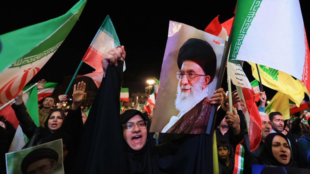 People take part in an anti-U.S. and anti-Israel rally at Enghelab Square in Tehran. Reuters