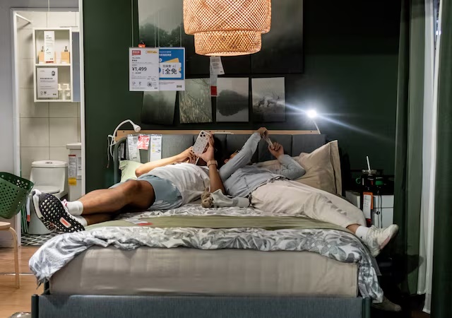 A couple rest on a bed in a showroom installation at an IKEA store in Beijing, China, July 5, 2026. REUTERS/Maxim Shemetov/File Photo