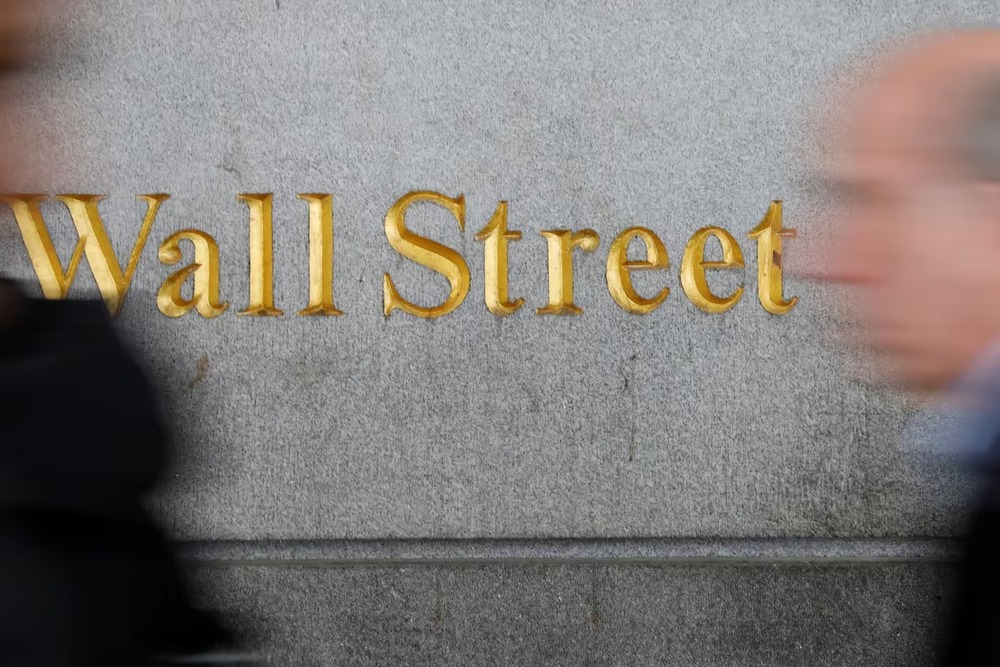 People walk by a Wall Street sign close to the New York Stock Exchange (NYSE) in New York, U.S., April 2, 2018. REUTERS People walk by a Wall Street sign close to the New York Stock Exchange (NYSE) in New York, U.S., April 2, 2018. REUTERS