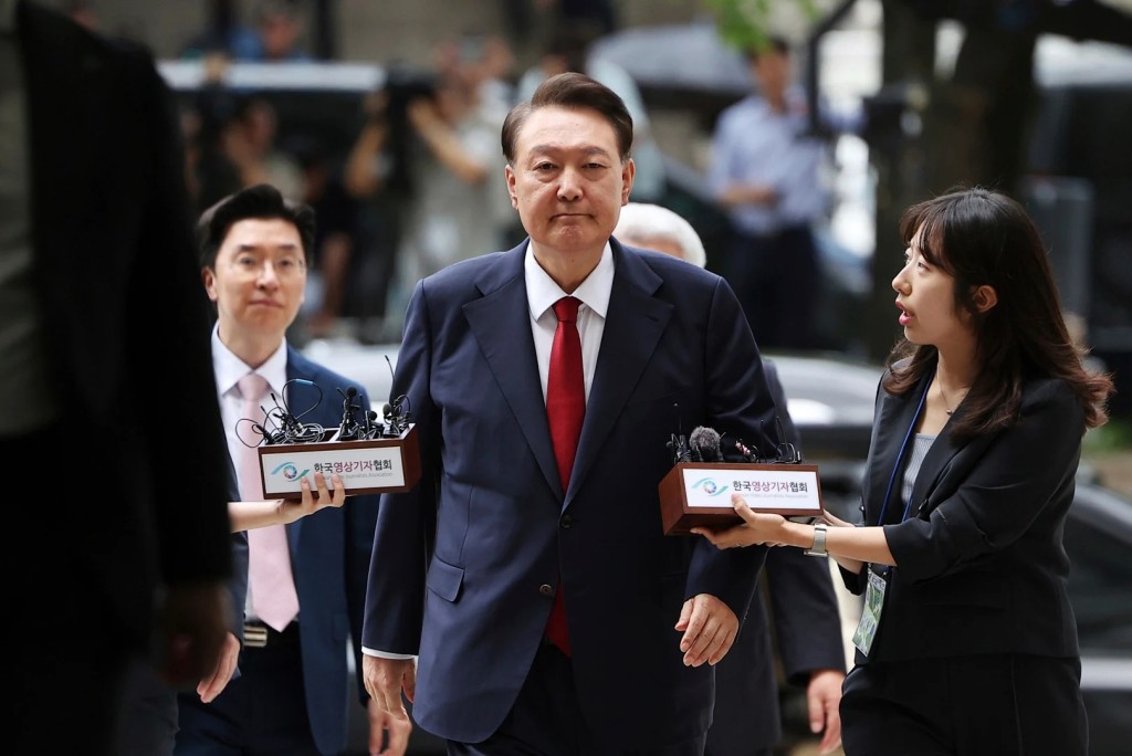 FILE - Former South Korean President Yoon Suk Yeol, center, arrives at a court to attend a hearing to review his arrest warrant requested by special prosecutors in Seoul, South Korea, on July 9, 2025. (Kim Hong-Ji/Pool Photo via AP, File)